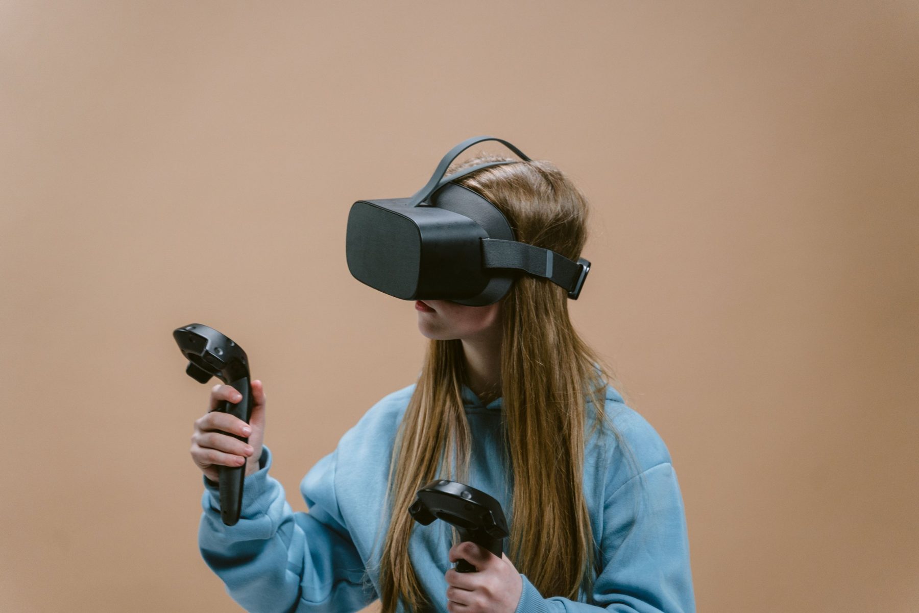 A person in a VR headset using motion controllers