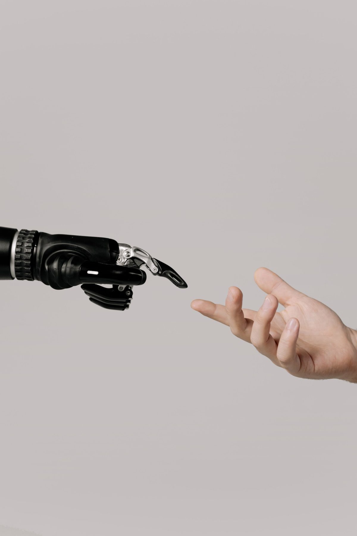 A robotic hand reaching toward a human hand