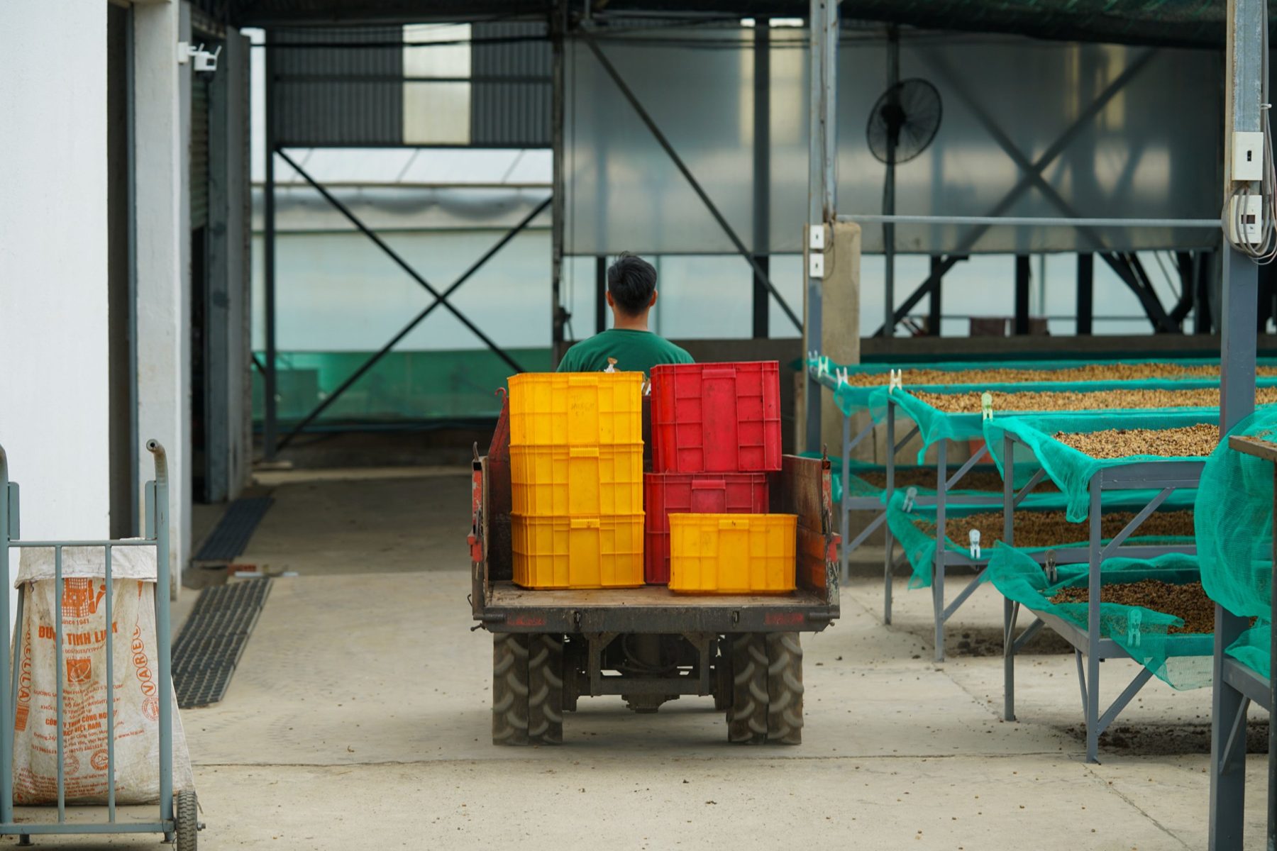 Crates being moved on a utility vehicle through a facility